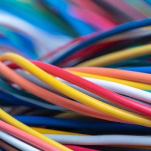 A spaghetti-like pile of intertwined cables in many different colors, including red, orange, yellow, blue, and white.