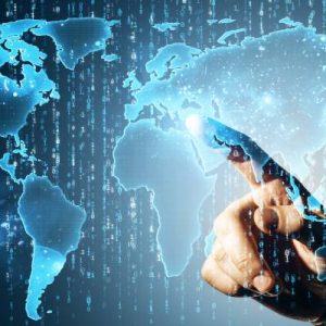 A close-up of a hand pointing at a glowing digital world map on a dark blue background. Binary code floats in the background.