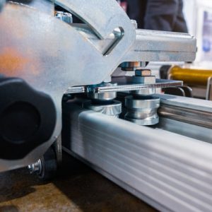 The side of a linear motion system with two rolling bolts placed between two long rails attached to the machine.