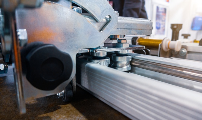 The side of a linear motion system with two rolling bolts placed between two long rails attached to the machine.