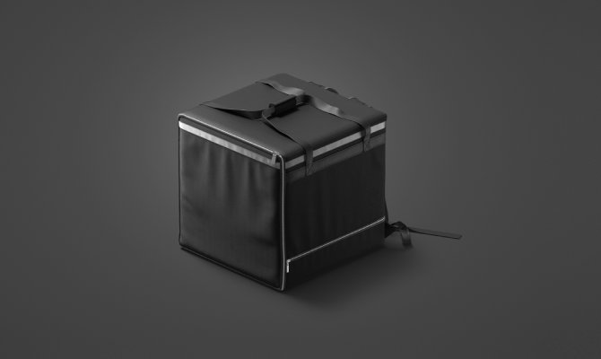 A black, square delivery bag with a silver zipper and black straps sits against a dark gray background.