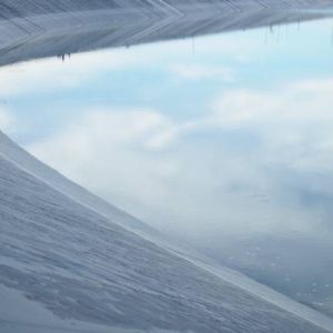 A close-up of the water line inside a tank lining material made of black high-density polyethylene.
