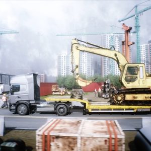 A semi hauling a large excavator on the back of a long trailer. Tall buildings and fog are behind the semi.
